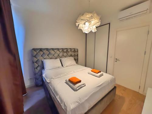a bedroom with a bed with two towels on it at BW Verde Icon in Belgrade