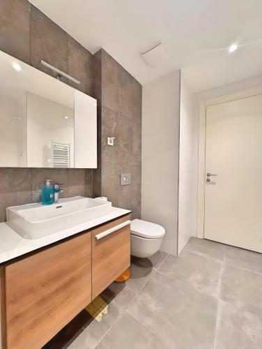 a bathroom with a white sink and a toilet at BW Verde Icon in Belgrade