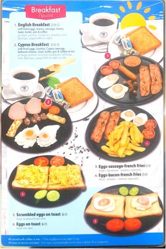a menu of breakfast foods on plates with cups of coffee at St. George Rent Rooms in Larnaka