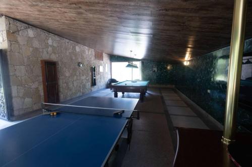 a ping pong table in a room with a pool table at Casa Paradise in Dilijan