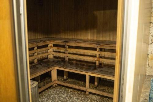a closet with wooden benches in a room at Casa Paradise in Dilijan