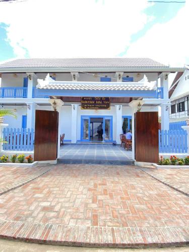 a blue and white building with a sign on it at Sadakham Royal View Hotel in Luang Prabang