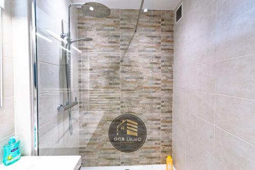 a bathroom with a shower with a stone wall at Lesdiguieres 3 Bedrooms Parking in Grenoble