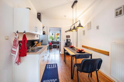 a kitchen and living room with a table and chairs at Tiny Home in Lübeck