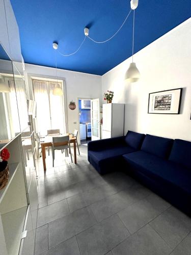 a living room with a blue couch and a table at Hbhall Residenze Darsena in Milan