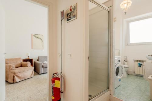 a bathroom with a shower and a washing machine at GuestHost - A Calanca - Comfy Le Grazie Apartment in Portovenere