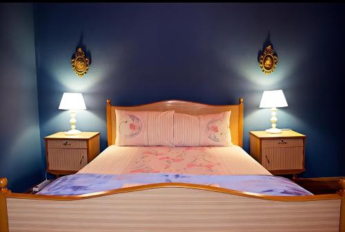 a bedroom with a large bed with two night stands at Grandmas Mansion 3BD Meteora - Rocks View in Kalabaka