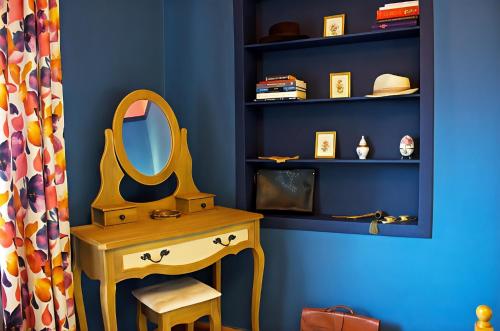 a blue room with a dressing table and a mirror at Grandmas Mansion 3BD Meteora - Rocks View in Kalabaka