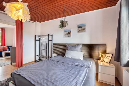 a bedroom with a bed and a wooden ceiling at Tiny Home in Lübeck