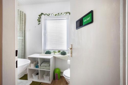 a bathroom with a toilet and a sink at Tiny Home in Lübeck