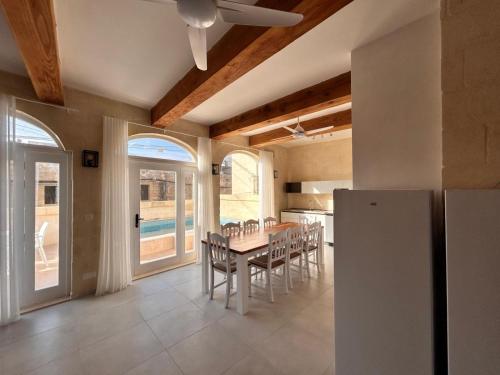 a kitchen and dining room with a table and chairs at Ta' Marija in Sannat