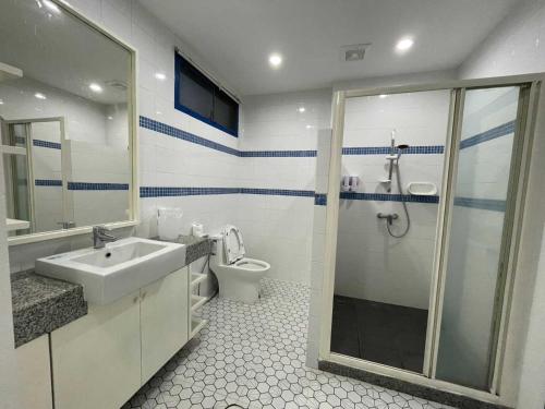 a bathroom with a shower and a sink and a toilet at To The Sea by Belvilla in Na Jomtien