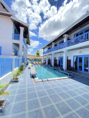 a swimming pool in the middle of a house at Sadakham Royal View Hotel in Luang Prabang