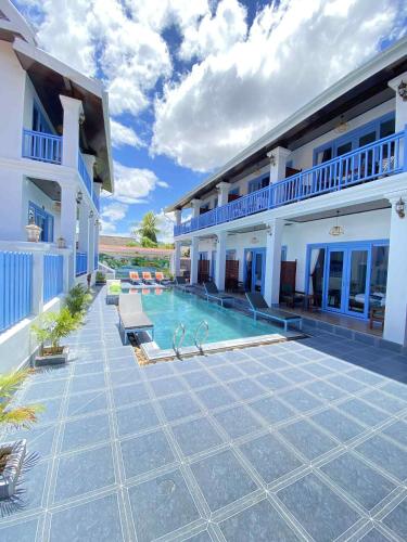 a swimming pool in front of a house at Sadakham Royal View Hotel in Luang Prabang