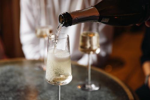 a bottle of champagne being poured into a glass at Eliot Arms in Cirencester