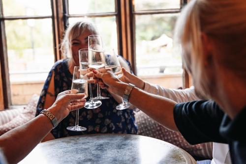 a group of people holding up glasses of wine at Eliot Arms in Cirencester