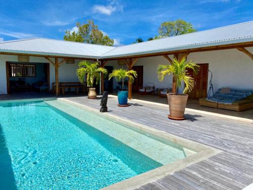 a villa with a swimming pool and a house at Vanille et Vahiné FR2PF8AL in Grand-Bourg