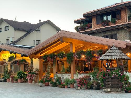 a building with flowers and an umbrella in front of it at B&B Massari in Preturo