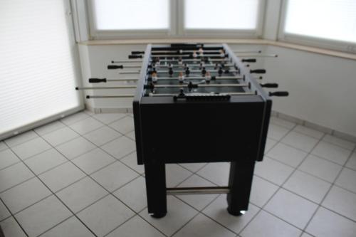 a room with a row of tables on a tiled floor at Großzügiges Erdgeschoßapartment mit Balkon und eigenen kostenlosen Parkplatz in Hövelhof