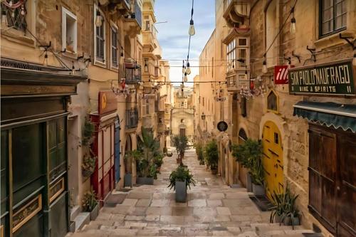 an alley in an old town with buildings at Medieval Knights house GF with Seaview at the Three Cities Marina in Senglea