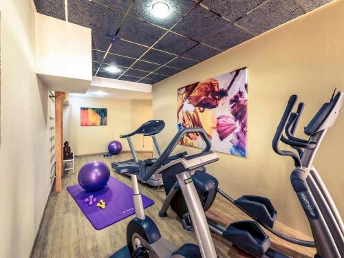 a gym with two exercise bikes in a room at PLAZA INN Regensburg in Regensburg