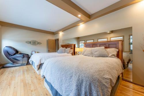 a bedroom with two beds and a chair at Dominion Hill Country Inn in Bocabec