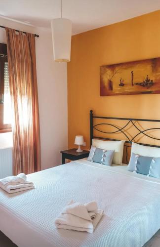 a bedroom with a bed with two towels on it at Aroma studios&apartments 2 in Vourvourou