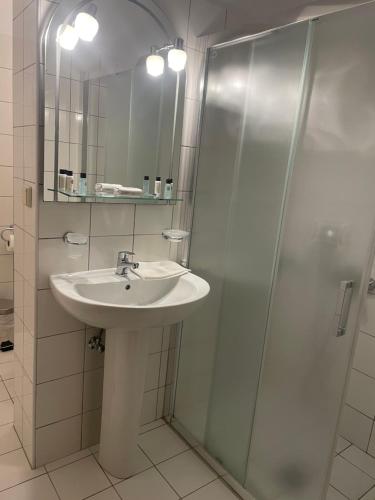 a bathroom with a sink and a shower at Studios Angeliki in Lassi
