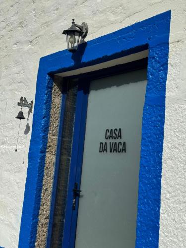 a blue door with a sign on a building at Quinta São José - Museu do Triciclo in Mesão Frio