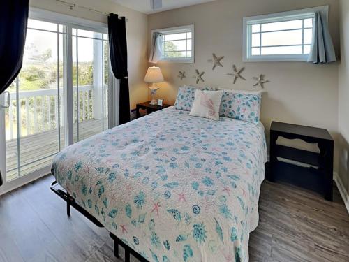 a bedroom with a large bed and a window at Lovin Lowe Tide in Thomas Landing