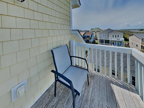 a blue chair sitting on the deck of a house at Lovin Lowe Tide in Thomas Landing