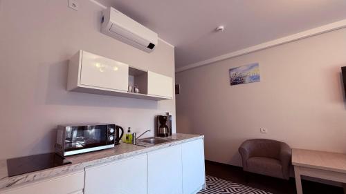 una cucina con lavandino e bancone con forno a microonde di SoLo a Kołobrzeg