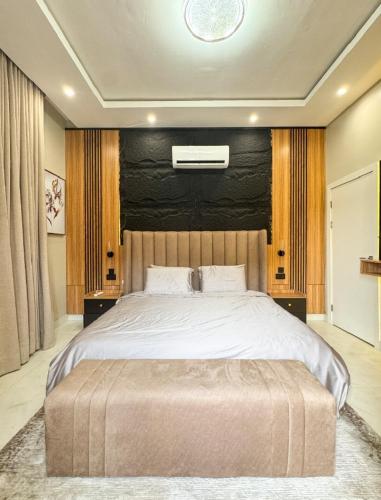 a bedroom with a large bed with a large white bedspread at Executive Pre 2 bedroom apartment in Surulere