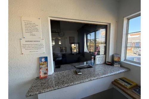 a counter in a restaurant with a mirror at Siesta Motor Inn By Townhouse Kennedy Space Center Titusville I 95 in Titusville