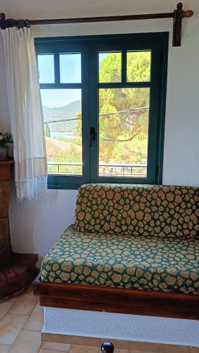 a room with a bed and a window with a view at Skardamoula's Studios n Apartments in Kardamili