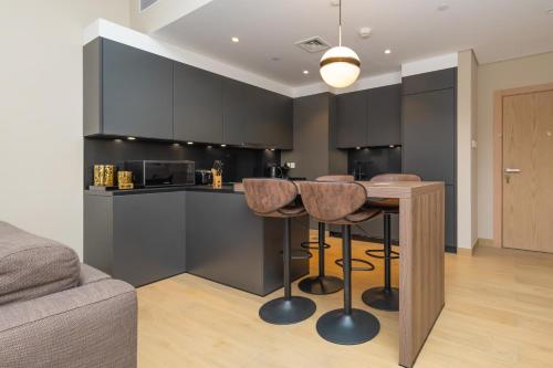 a kitchen with a table and chairs in a room at Port de la Mer Luxury Sleeps 4Person in Dubai