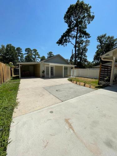 a house with a driveway in front of it at Peaceful Forest Shadow in Humble
