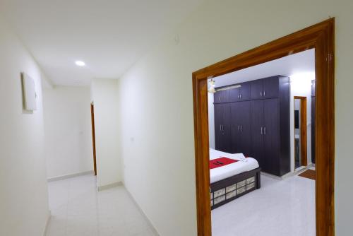 a mirror in a room with a bed in it at SBHS Venkatadri Homestay in Tirupati