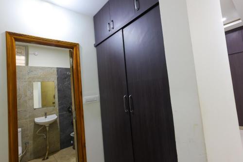 a bathroom with a black cabinet and a sink at SBHS Venkatadri Homestay in Tirupati
