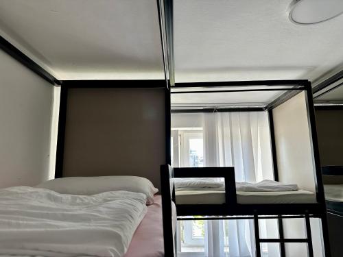 a bedroom with two bunk beds and a window at Shesh Center Hostel in Pristina