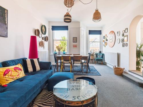 a living room with a blue couch and a table at The Lynton Lookout in Margate