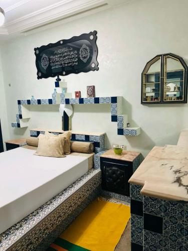 a room with a bed and a table and stairs at Dar Zakia in Tunis