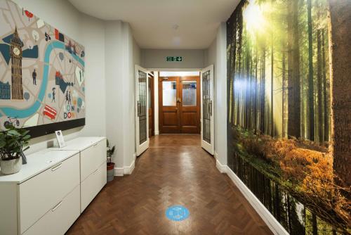 an office hallway with a large painting on the wall at London City Hotel in Woolwich