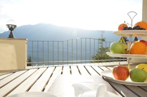 a plate of fruit on a table on a balcony at Wellness Aparthotel Panorama Alpin - Ferienwohnungen Jerzens im Pitztal in Jerzens