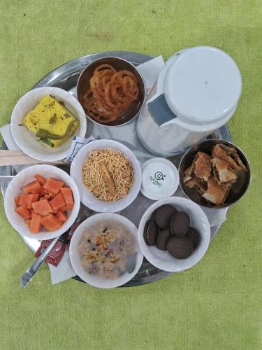 a tray filled with different types of food on a table at Kailash Haveli in Bikaner