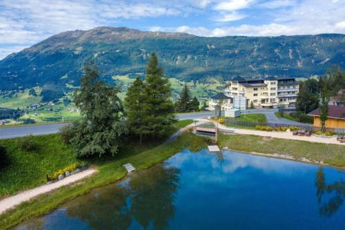 an aerial view of a river with houses and a mountain at Wellness Aparthotel Panorama Alpin - Ferienwohnungen Jerzens im Pitztal in Jerzens