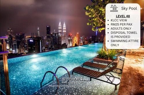 a swimming pool with a city skyline in the background at Expressionz KLCC by Wodages, 300mbps Wifi in Kuala Lumpur