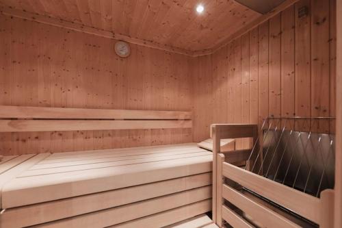 a sauna with two bunk beds and a clock at Wellness Aparthotel Panorama Alpin - Ferienwohnungen Jerzens im Pitztal in Jerzens
