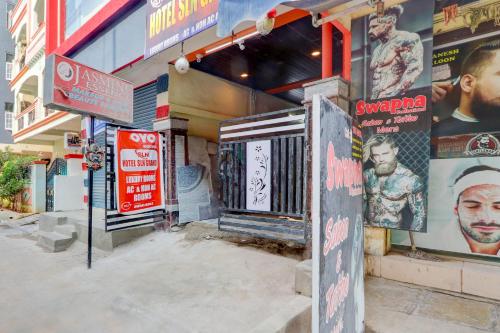 a building with posters on the side of it at Hotel O S L N Grand in Upal