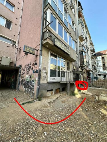 a red frisbee in front of a building at Shesh Center Hostel in Pristina